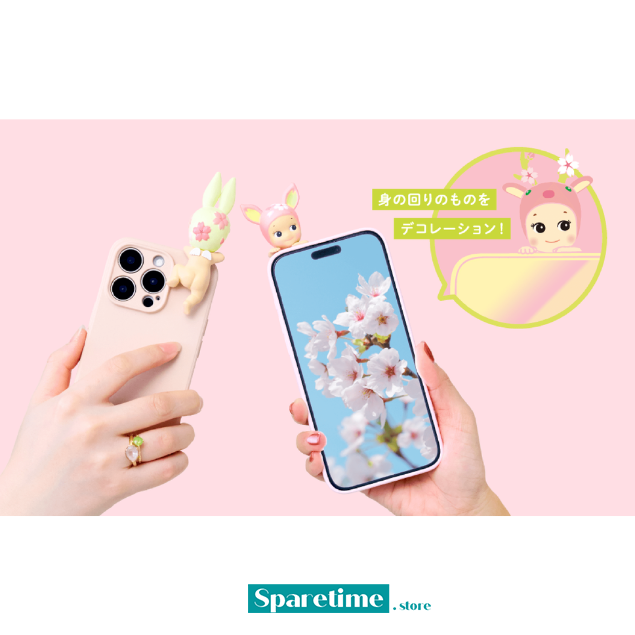 Smartphone with a cherry blossom design held by a hand, with another phone case featuring a cartoon character on a pink background.