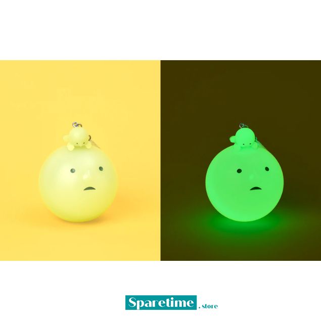 Two round, face-like objects, one yellow and one green, on a split background with &